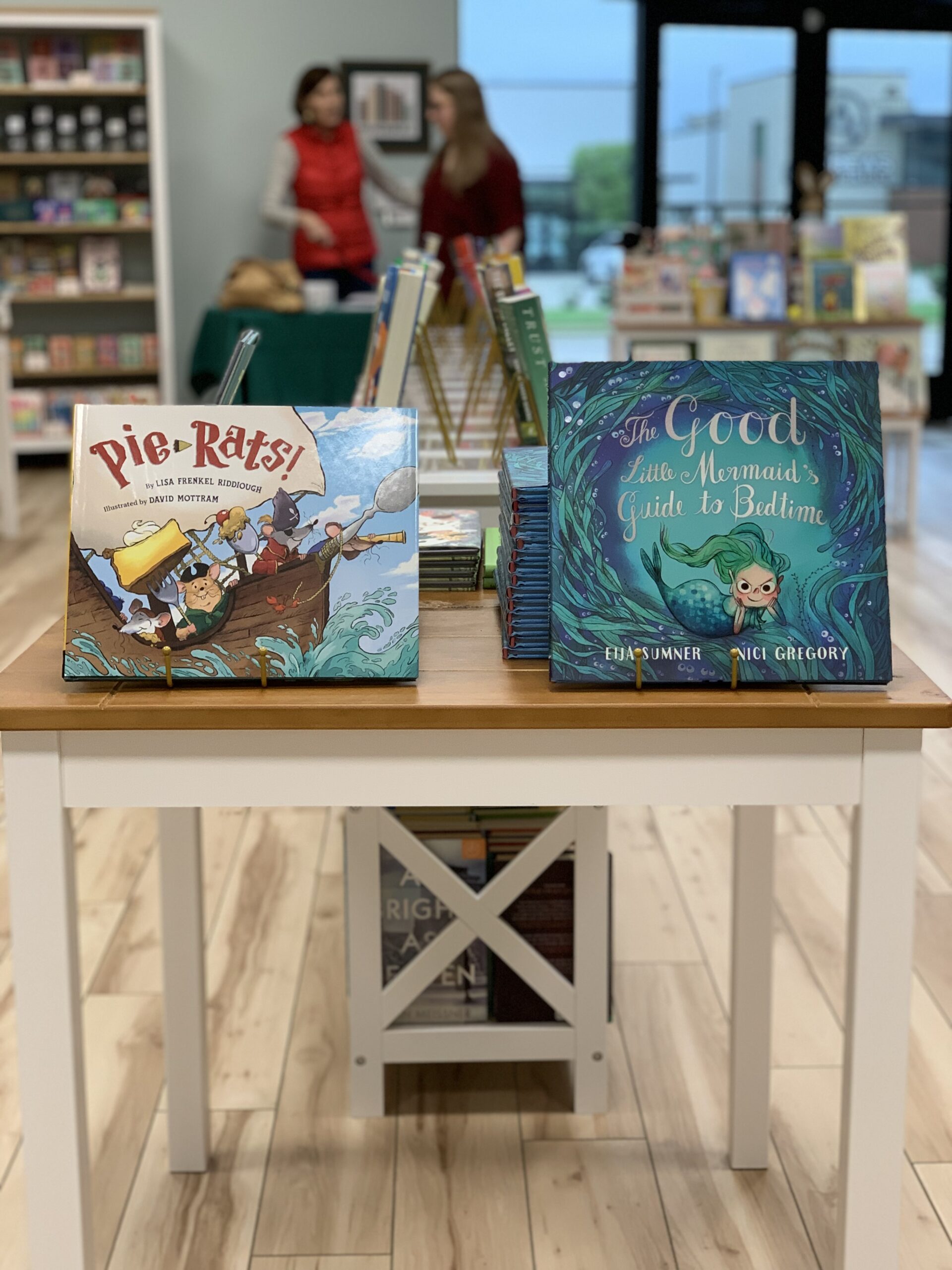 Pie Rats and the Good Little Mermaid's Guide to Bedtime picture books on a table in Hyperbole Bookstore